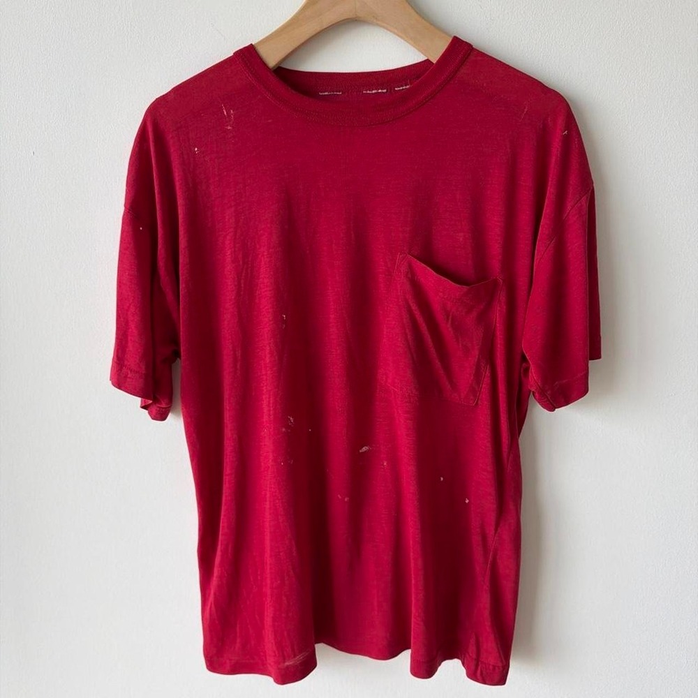 Vintage red pocket tee with a worn-in, faded look